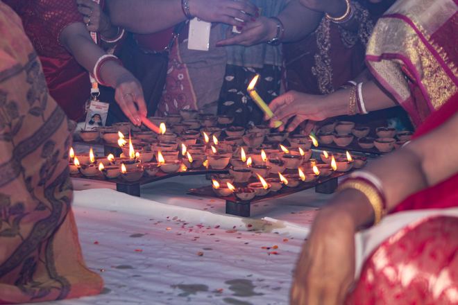 Devotees lighting diyas
