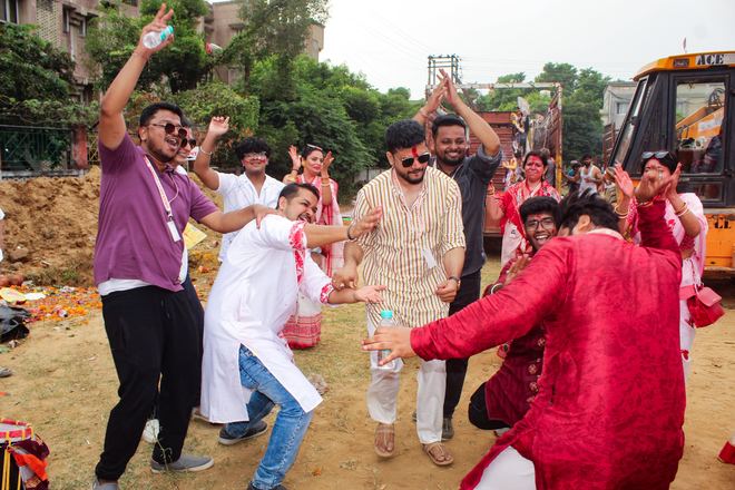 Community members dancing during Bijoya