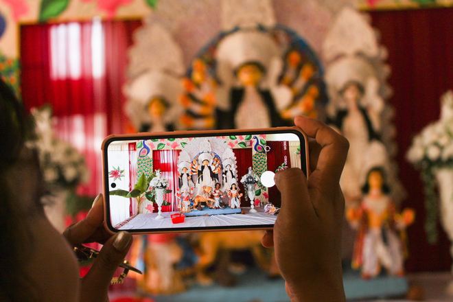 Devotee photographing the Durga idol