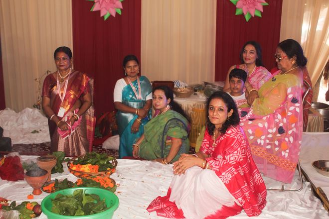 Women members gathered around puja offerings